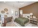Bedroom featuring wood floors, accent wall, ceiling lights, attached bathroom and modern decor at 43712 N Acadia Way, New River, AZ 85087