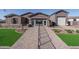 Beautiful model home showcasing desert landscape, brick pathway and stunning exterior elevation at 43712 N Acadia Way, New River, AZ 85087