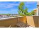 Cozy balcony featuring wood furniture and views of the landscaped courtyard and blue sky at 4600 N 68Th St # 370, Scottsdale, AZ 85251