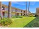 Well-maintained condo complex featuring lush landscaping, blue sky, and palm trees at 4600 N 68Th St # 370, Scottsdale, AZ 85251