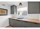 Modern kitchen sink with undermount sink, butcher block countertops, and gray cabinets at 4600 N 68Th St # 370, Scottsdale, AZ 85251