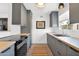 Bright kitchen showcasing modern gray cabinetry, an undermount sink, and a colorful area rug at 4600 N 68Th St # 370, Scottsdale, AZ 85251