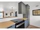 Modern kitchen featuring sleek gray cabinetry, stainless steel appliances, and butcher block countertops at 4600 N 68Th St # 370, Scottsdale, AZ 85251