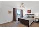 Comfortable primary bedroom with a wood bed frame, ceiling fan, and serene decor at 4600 N 68Th St # 370, Scottsdale, AZ 85251
