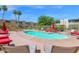 Inviting community pool with lounge chairs and shade umbrellas, perfect for summer days at 4600 N 68Th St # 370, Scottsdale, AZ 85251