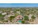 Expansive aerial view showcasing the home's tile roof, backyard pool, and desert surroundings at 4727 E Rancho Caliente Dr, Cave Creek, AZ 85331