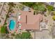 Aerial view of a private backyard oasis with a pool, patio, and lush desert landscaping at 4727 E Rancho Caliente Dr, Cave Creek, AZ 85331