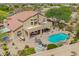 Lush backyard with a swimming pool, patio furniture, built in barbecue and desert landscaping at 4727 E Rancho Caliente Dr, Cave Creek, AZ 85331