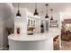 Open bar area with wraparound quartz countertop, pendant lighting, and seating at 4727 E Rancho Caliente Dr, Cave Creek, AZ 85331