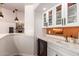 Home bar with stone accents, white cabinetry, quartz countertops, and wine fridge at 4727 E Rancho Caliente Dr, Cave Creek, AZ 85331