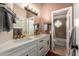 Bathroom with double sinks, quartz countertops, and an art-deco window to the toilet and shower at 4727 E Rancho Caliente Dr, Cave Creek, AZ 85331