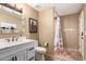 Neutral bathroom featuring a vanity with marble countertop and framed mirror and a walk-in shower with tile flooring at 4727 E Rancho Caliente Dr, Cave Creek, AZ 85331