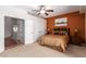Cozy bedroom featuring an earth-toned accent wall, ceiling fan, and convenient access to the bathroom at 4727 E Rancho Caliente Dr, Cave Creek, AZ 85331