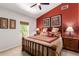 Inviting bedroom featuring an accent wall, natural light, and comfortable furnishings at 4727 E Rancho Caliente Dr, Cave Creek, AZ 85331