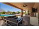Outdoor patio with a full kitchen, a tv, a ceiling fan, and comfortable seating area with a pool view at 4727 E Rancho Caliente Dr, Cave Creek, AZ 85331