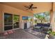 Inviting covered patio featuring a full kitchen and seating, with sliding glass doors leading to a pool and desert landscape at 4727 E Rancho Caliente Dr, Cave Creek, AZ 85331