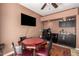 Dining area with a card table, chairs, a TV, and small fridge area at 4727 E Rancho Caliente Dr, Cave Creek, AZ 85331