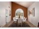 Bright dining room with large arched window, tile flooring, and seating for eight at 4727 E Rancho Caliente Dr, Cave Creek, AZ 85331
