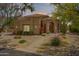 Beautiful home with desert landscaping, a tile roof, and arched entryway at 4727 E Rancho Caliente Dr, Cave Creek, AZ 85331