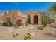 Desert home with a stone pathway, mature desert landscaping, and a covered entryway at 4727 E Rancho Caliente Dr, Cave Creek, AZ 85331