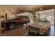 Spacious two-car garage showcasing a car and SUV and featuring high ceilings and ample lighting at 4727 E Rancho Caliente Dr, Cave Creek, AZ 85331