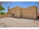 Home's exterior showcasing a three-car garage and spiral staircase, complemented by desert landscaping at 4727 E Rancho Caliente Dr, Cave Creek, AZ 85331