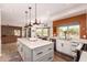 Bright kitchen with large island, stainless appliances, and breakfast nook with pool view at 4727 E Rancho Caliente Dr, Cave Creek, AZ 85331
