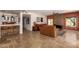 Spacious living room featuring stone fireplace, bar, and tile flooring at 4727 E Rancho Caliente Dr, Cave Creek, AZ 85331