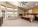 Bright main bedroom featuring large windows, neutral tones, a ceiling fan, and a cozy seating area at 4727 E Rancho Caliente Dr, Cave Creek, AZ 85331