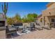 Comfortable outdoor patio area with stylish seating, a cozy fireplace, and serene desert surroundings at 4727 E Rancho Caliente Dr, Cave Creek, AZ 85331