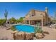 Stunning backyard showcasing a sparkling pool, lush landscaping, and a relaxing outdoor living space at 4727 E Rancho Caliente Dr, Cave Creek, AZ 85331