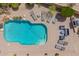 Aerial view of a sparkling pool surrounded by pavers and desert landscaping, perfect for relaxation at 4727 E Rancho Caliente Dr, Cave Creek, AZ 85331