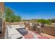 Spacious rooftop deck with cozy outdoor furniture and views of mature desert landscaping against a blue sky at 4727 E Rancho Caliente Dr, Cave Creek, AZ 85331