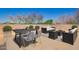 Rooftop deck with modern seating areas, views of mature landscaping, and a clear blue sky at 4727 E Rancho Caliente Dr, Cave Creek, AZ 85331