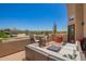 Desert landscape view from spacious rooftop deck with outdoor furniture including a sofa and dining set at 4727 E Rancho Caliente Dr, Cave Creek, AZ 85331