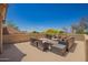 Open rooftop deck with comfortable seating areas and views of mature trees, tile roofing, and blue skies at 4727 E Rancho Caliente Dr, Cave Creek, AZ 85331