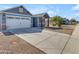 View of the home with a long driveway and two-car garage, showcasing its curb appeal at 4732 S 38Th Gln, Phoenix, AZ 85041