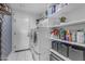 Well-organized laundry room with shelving, modern washer, and dryer appliances for efficient chores at 4732 S 38Th Gln, Phoenix, AZ 85041