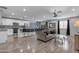 Spacious living area featuring a kitchen island with barstools, a sofa, and stainless appliances at 4732 S 38Th Gln, Phoenix, AZ 85041