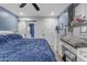 Bedroom features a modern ceiling fan and an en-suite bathroom with barn door at 4732 S 38Th Gln, Phoenix, AZ 85041