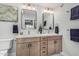 Bright bathroom with dual sinks, vanity, mirrors, and stylish fixtures, offering a functional space at 4950 N 78Th St, Scottsdale, AZ 85251