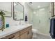 Stylish bathroom featuring a glass-enclosed shower, modern vanity, and decorative accents at 4950 N 78Th St, Scottsdale, AZ 85251