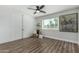 Minimalist bedroom with ceiling fan, storage, and a large window at 4950 N 78Th St, Scottsdale, AZ 85251