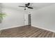 Bright bedroom featuring wood floors, ceiling fan, neutral paint, and an open door at 4950 N 78Th St, Scottsdale, AZ 85251
