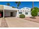 Inviting home with desert landscaping, a covered parking area, and a decorative front door at 4950 N 78Th St, Scottsdale, AZ 85251