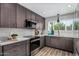 Modern kitchen with stainless steel appliances, custom cabinetry, and stylish countertops at 4950 N 78Th St, Scottsdale, AZ 85251