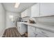 Well-lit laundry room with white cabinets, counter space, washer, and dryer hookups at 4950 N 78Th St, Scottsdale, AZ 85251