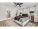Elegant main bedroom with ensuite bathroom access, ceiling fan, and modern decor elements at 4950 N 78Th St, Scottsdale, AZ 85251
