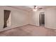 Comfortable bedroom with ceiling fan, carpet, and a window providing natural light at 501 E Hill Dr, Avondale, AZ 85323