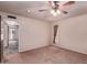 Neutral bedroom with ceiling fan, carpet, and a view to the living room at 501 E Hill Dr, Avondale, AZ 85323